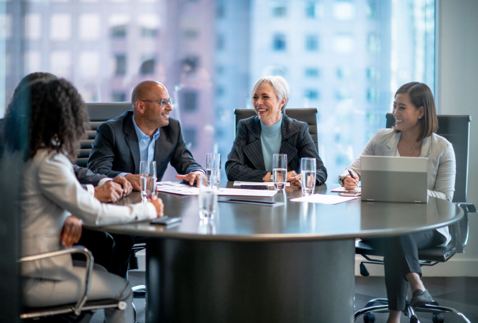Business meeting with diverse professionals around table.
