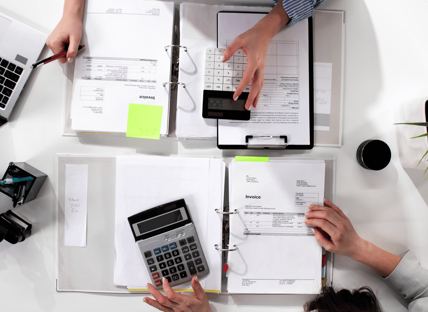 People working with calculators and documents.